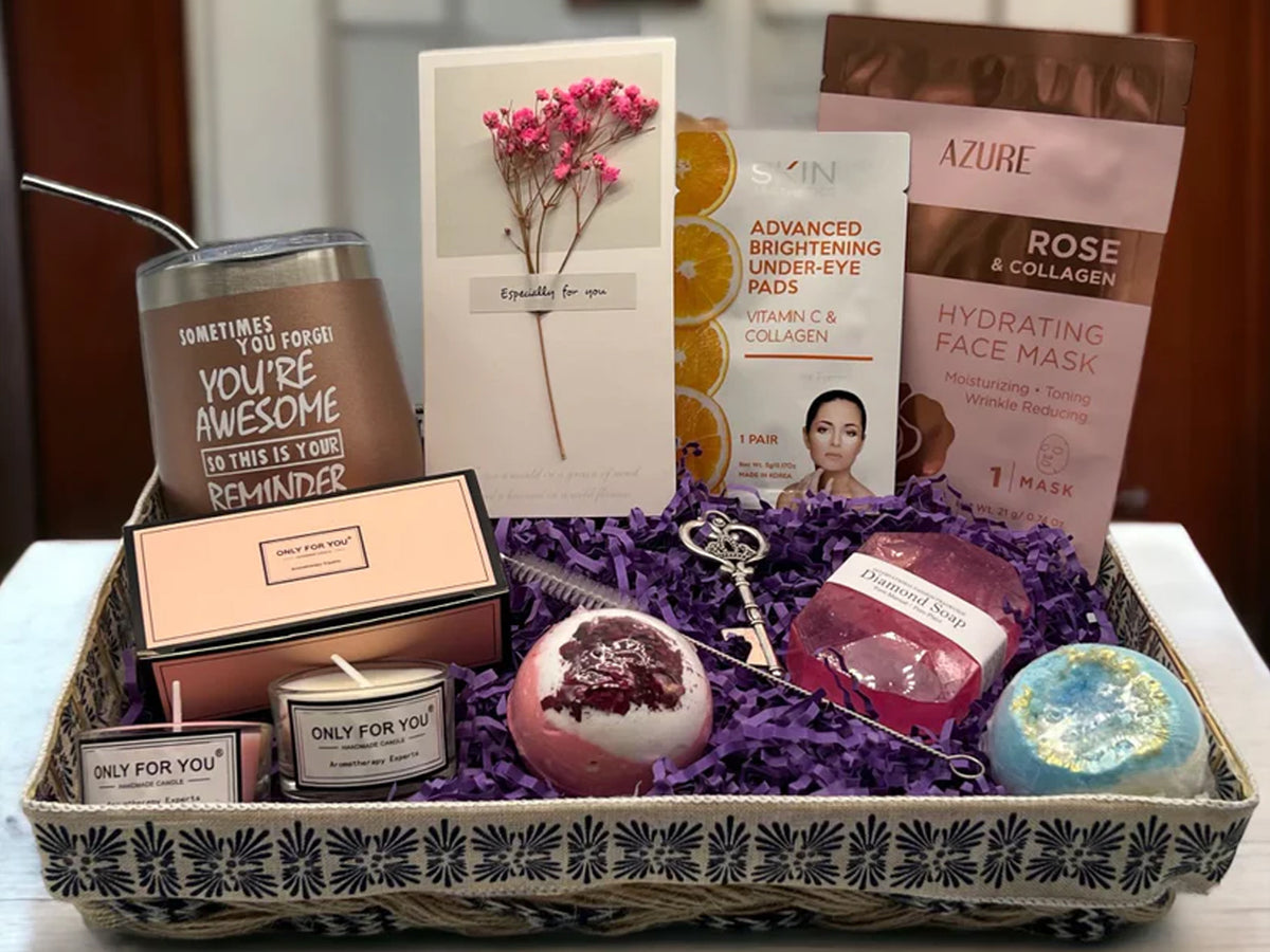 A One Craft Stop gift basket packed by hand — candles, soaps, a keepsake card and a tumbler in a woven tray